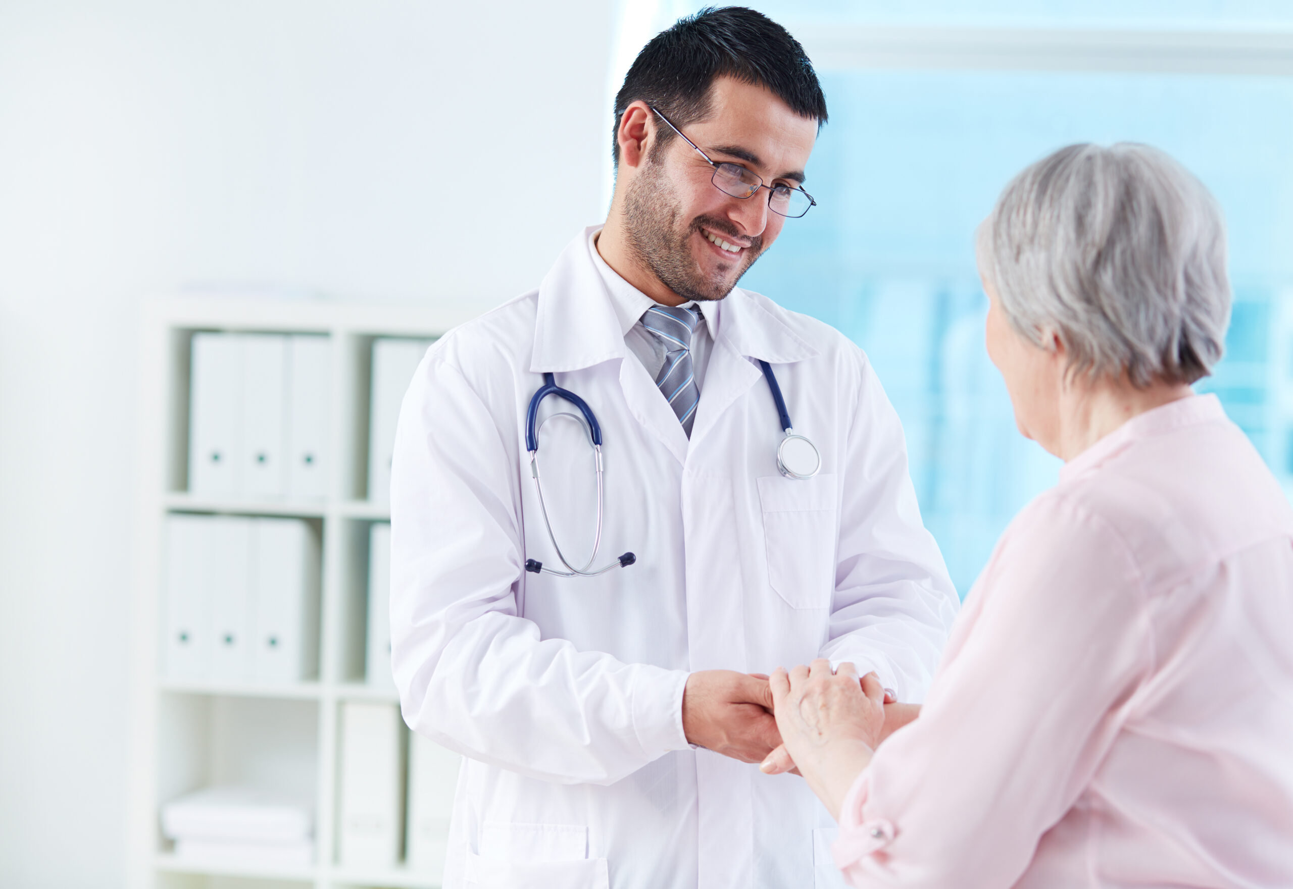 Speaking with patient Confident doctor looking at his senior patient while speaking to her